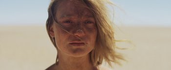 Movie still from “Tracks” (2013), directed by John Curran – A person's face with hair blowing in the wind; Close Up shot, Low angle