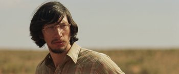 Movie still from “Tracks” (2013), directed by John Curran – A person wearing glasses and a plaid shirt; Close Up shot, Low angle