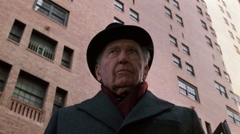 Movie still from “Trading Places” (1983), directed by John Landis – An older man wearing a hat and a coat; Close Up shot, Low angle