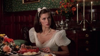 Movie still from “Trading Places” (1983), directed by John Landis – A woman sitting at a table with a plate of lobster; Close Up shot, Over the shoulder angle