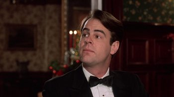 Movie still from “Trading Places” (1983), directed by John Landis – A man wearing a tuxedo and a bow tie looking to his left; Close Up shot, Low angle