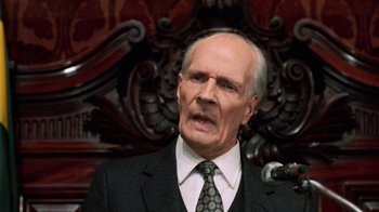 Movie still from “Trading Places” (1983), directed by John Landis – An older man wearing a suit and tie; Close Up shot, Low angle