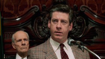 Movie still from “Trading Places” (1983), directed by John Landis – A person wearing a suit and a tie; Close Up shot, Low angle