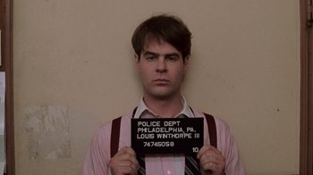 Movie still from “Trading Places” (1983), directed by John Landis – A man holding up a black and white photo; Close Up shot, Low angle