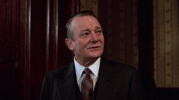 Movie still from “Trading Places” (1983), directed by John Landis – An older man wearing a suit and tie; Close Up shot, Low angle