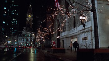Movie still from “Trading Places” (1983), directed by John Landis – People walking down the street at night with christmas lights; Extreme Wide shot, High angle