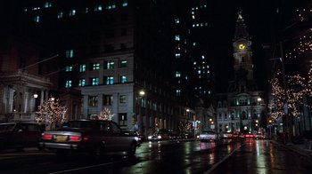 Movie still from “Trading Places” (1983), directed by John Landis – A city street at night lit up by street lights; Extreme Wide shot, High angle