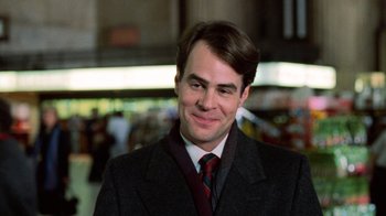 Movie still from “Trading Places” (1983), directed by John Landis – A person wearing a suit and tie; Close Up shot, Over the shoulder angle