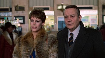 Movie still from “Trading Places” (1983), directed by John Landis – A man and a woman standing next to each other; Medium shot, Over the shoulder angle