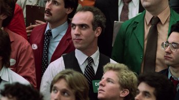 Movie still from “Trading Places” (1983), directed by John Landis – A group of people sitting in a room; Close Up shot, Over the shoulder angle