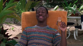 Movie still from “Trading Places” (1983), directed by John Landis – A man holding a glass of wine in his hand; Medium shot, High angle