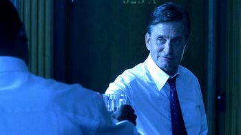 Movie still from “Traffic” (2000), directed by Steven Soderbergh – A man in a white dress shirt and tie holding a glass of water; Close Up shot, Over the shoulder angle