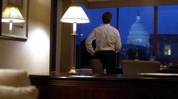 Movie still from “Traffic” (2000), directed by Steven Soderbergh – A man standing in front of a window looking at the capitol building; Wide shot, Low angle
