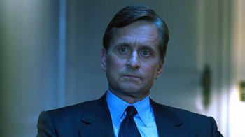 Movie still from “Traffic” (2000), directed by Steven Soderbergh – A person wearing a suit and tie; Close Up shot, Low angle