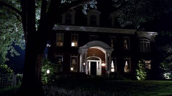 Movie still from “Traffic” (2000), directed by Steven Soderbergh – A large building with a large porch at night time; Extreme Wide shot, Low angle