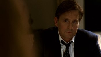 Movie still from “Traffic” (2000), directed by Steven Soderbergh – A person wearing a suit and tie; Close Up shot, Over the shoulder angle