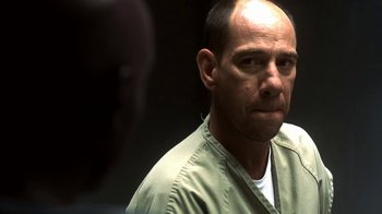 Movie still from “Traffic” (2000), directed by Steven Soderbergh – A man with a bald head is looking at the camera; Close Up shot, Over the shoulder angle