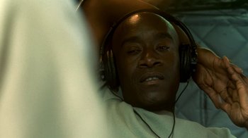 Movie still from “Traffic” (2000), directed by Steven Soderbergh – A person wearing headphones; Close Up shot, Overhead angle