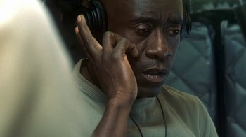 Movie still from “Traffic” (2000), directed by Steven Soderbergh – A person wearing headphones; Close Up shot, High angle