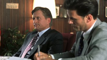 Movie still from “Traffic” (2000), directed by Steven Soderbergh – Two men in business suits sitting at a table with a pen; Close Up shot, Over the shoulder angle
