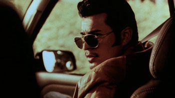 Movie still from “Traffic” (2000), directed by Steven Soderbergh – A man with sunglasses sitting in the driver's seat of a car; Close Up shot, Low angle