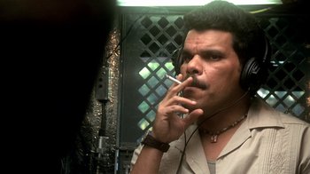 Movie still from “Traffic” (2000), directed by Steven Soderbergh – A man smoking a cigarette while listening to music; Close Up shot, Low angle