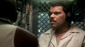 Movie still from “Traffic” (2000), directed by Steven Soderbergh – A person wearing headphones; Close Up shot, Low angle