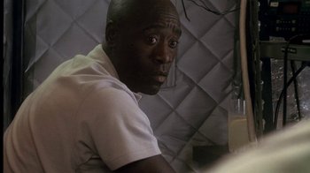 Movie still from “Traffic” (2000), directed by Steven Soderbergh – A person sitting at a table; Close Up shot, Over the shoulder angle