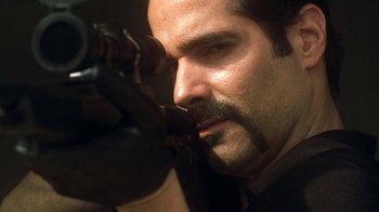 Movie still from “Traffic” (2000), directed by Steven Soderbergh – A person with a beard and mustache; Close Up shot, Over the shoulder angle
