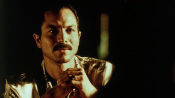 Movie still from “Traffic” (2000), directed by Steven Soderbergh – A person with a beard and mustache; Close Up shot, Low angle