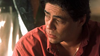 Movie still from “Traffic” (2000), directed by Steven Soderbergh – A person wearing a red shirt; Close Up shot, Low angle