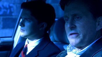 Movie still from “Traffic” (2000), directed by Steven Soderbergh – Two men sitting in the back seat of a car at night; Close Up shot, Over the shoulder angle