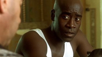 Movie still from “Traffic” (2000), directed by Steven Soderbergh – A person wearing a tank top; Close Up shot, High angle