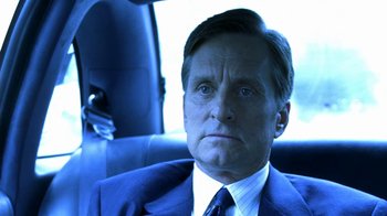 Movie still from “Traffic” (2000), directed by Steven Soderbergh – A person wearing a suit in a car; Close Up shot, Low angle