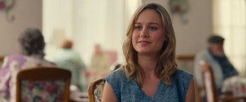 Movie still from “Trainwreck” (2015), directed by Judd Apatow – A woman sitting in a chair looking at the camera; Close Up shot, Over the shoulder angle