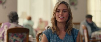 Movie still from “Trainwreck” (2015), directed by Judd Apatow – A woman sitting at a table in front of a window; Close Up shot, Over the shoulder angle