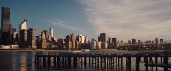 Movie still from “Trainwreck” (2015), directed by Judd Apatow – A view of a city from across the water; Extreme Wide shot, High angle