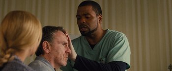 Movie still from “Trainwreck” (2015), directed by Judd Apatow – A doctor is examining a man's head; Close Up shot, Over the shoulder angle