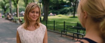 Movie still from “Trainwreck” (2015), directed by Judd Apatow – A woman standing in a park near a bench; Close Up shot, Over the shoulder angle