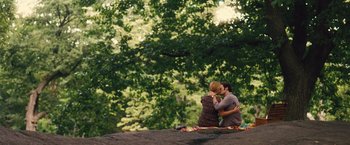 Movie still from “Trainwreck” (2015), directed by Judd Apatow – A man and a woman sitting on top of a rock; Extreme Wide shot, High angle