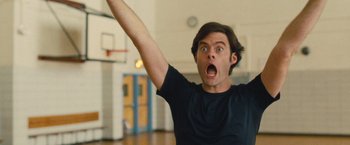 Movie still from “Trainwreck” (2015), directed by Judd Apatow – A man with a surprised look on his face holding up his arm; Close Up shot, Low angle
