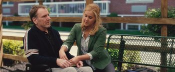 Movie still from “Trainwreck” (2015), directed by Judd Apatow – A woman sitting on a park bench with a man; Medium shot, Over the shoulder angle