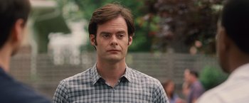 Movie still from “Trainwreck” (2015), directed by Judd Apatow – A person wearing a plaid shirt; Close Up shot, Over the shoulder angle