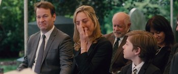 Movie still from “Trainwreck” (2015), directed by Judd Apatow – A woman in a black suit is holding her nose; Close Up shot, Over the shoulder angle