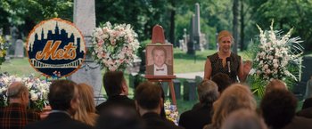 Movie still from “Trainwreck” (2015), directed by Judd Apatow – A portrait of a man in front of people in a cemetery; Medium shot, Over the shoulder angle
