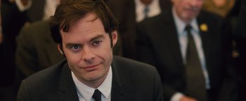 Movie still from “Trainwreck” (2015), directed by Judd Apatow – A man in a suit and tie looking at the camera; Close Up shot, Over the shoulder angle