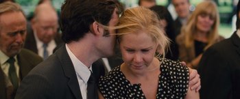 Movie still from “Trainwreck” (2015), directed by Judd Apatow – A man and a woman are kissing each other; Close Up shot, Over the shoulder angle
