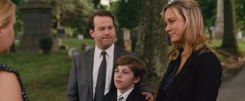 Movie still from “Trainwreck” (2015), directed by Judd Apatow – A man and a woman standing next to a young boy; Medium shot, Over the shoulder angle