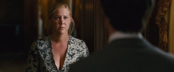 Movie still from “Trainwreck” (2015), directed by Judd Apatow – A woman looking at a man in the mirror; Close Up shot, Over the shoulder angle
