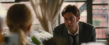 Movie still from “Trainwreck” (2015), directed by Judd Apatow – A person wearing a suit and tie; Close Up shot, Over the shoulder angle